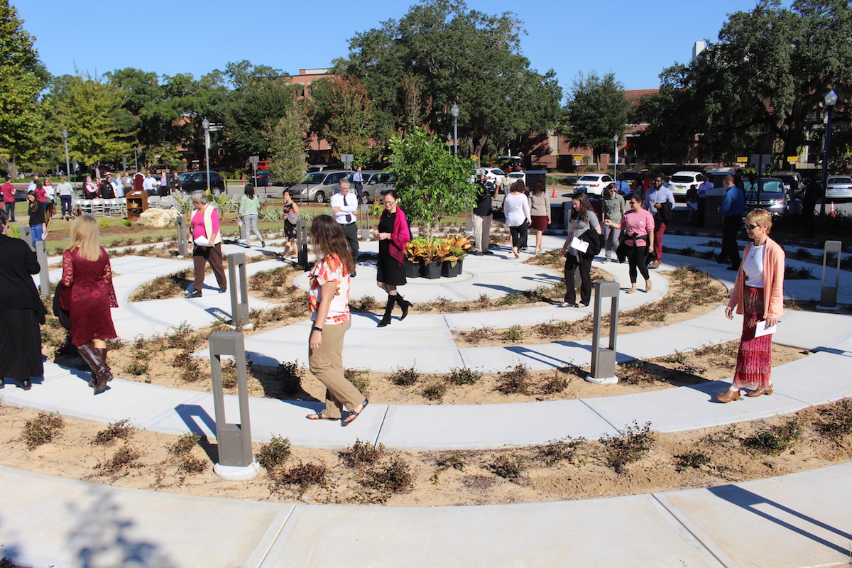 Attendees of the grand opening of the new Florida State University Labyrinth take an inaugural walk along the newest space on campus devoted to reflection and well-being on Nov. 2, 2017